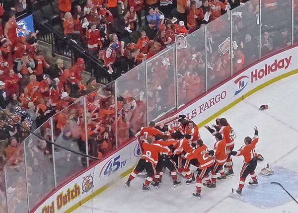 Grand Rapids players carried the state trophy over to share with their orange-clad fans. Photo credit: John Gilbert