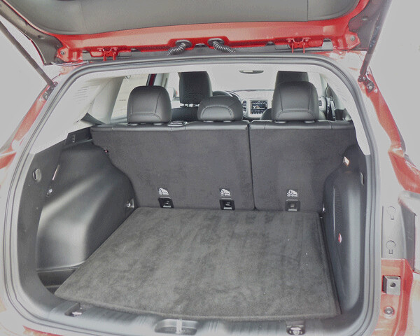 Lifting the hatch reveals a spacious rear storage compartment, with space-saver spare under the carpet. Photo credit: John Gilbert