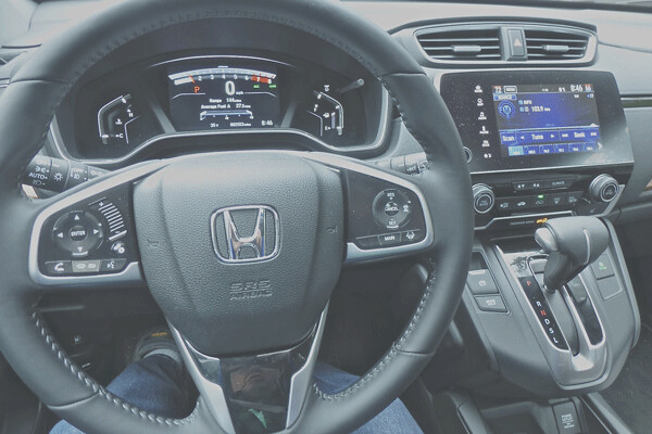 Driver's eye view of the controls features a switch-filled steering wheel, and the touch-screen adjusts audio settings. Photo credit: John Gilbert