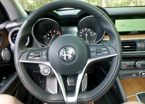 The flat-bottom steering wheel shows off Alfa’s logo and tips off the feeling of control you are about to experience. Photo credit: John Gilbert