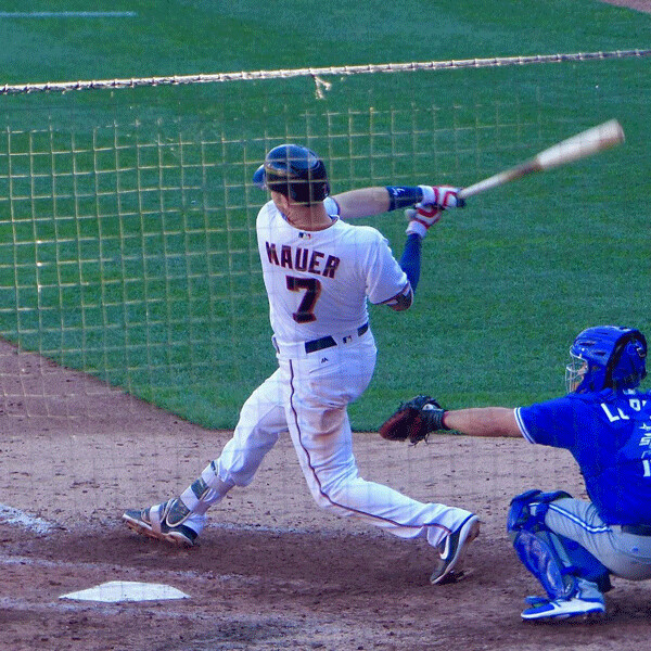 Joe Mauer's swing remains a thing of beauty, even through mesh, when he hits a game-breaking grand slam as he did on this pitch Sunday. Photo credit: John Gilbert