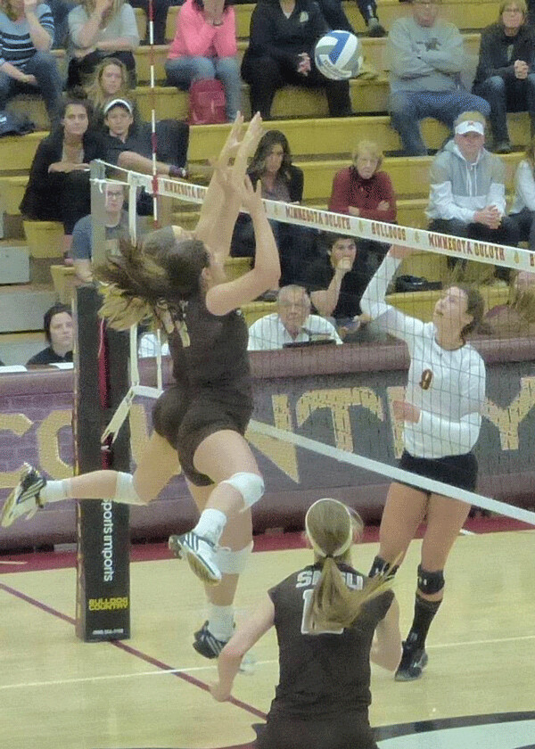 UMD's Sarah Kelly (9) crossed up Southwest Minnesota State  blockers with a change-up, lobbing a shot just over their reach... Photo credit: John Gilbert