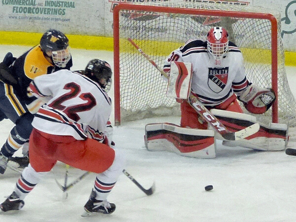 East junior goaltender Lukan Hanson got help from Ryder Donovan (22) and blocked everything after Wayzata took a 2-1 lead as the Greyhounds came back. Photo credit: John Gilbert