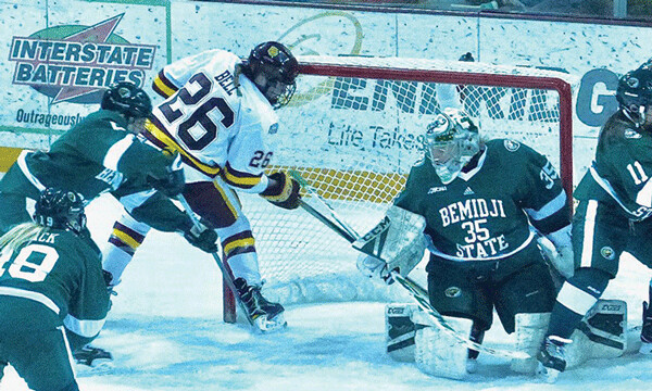 UMD freshman Ashton Bell spotted the puck under Bemidji State goaltender Lauren Bench and went after it, knocking in her second goal of the game, and what proved to be the 3-2 game-winner Saturday night. Photo credit: John Gilbert