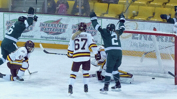 Bailey Wright (left) scored a short-side goal on UMD goaltender Jessica Convery in the midst of four unanswered Bemidji State goals in Friday's 5-3 victory over UMD. Photo credit: John Gilbert