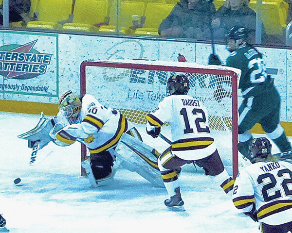 UMD goalie Jessica Convery pounced on a loose puck during the first game of the Bemidji State series. Photo credit: John Gilbert