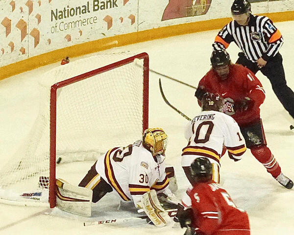 Freshman Naomi Rogge followed up her UMD team-leading 13th goal with a big smile from behind the net. Photo credit: John Gilbert