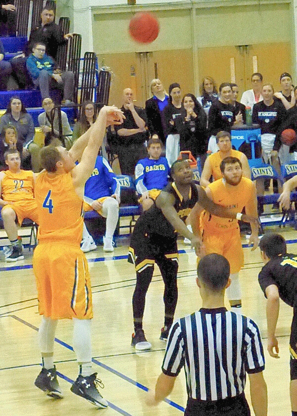 After missing the first free throw, St. Scholastica’s Brandon Newman calmly sank the second, with 0:00.3 left for an 80-79 victory over Wisconsin-Superior. Photo credit: John Gilbert
