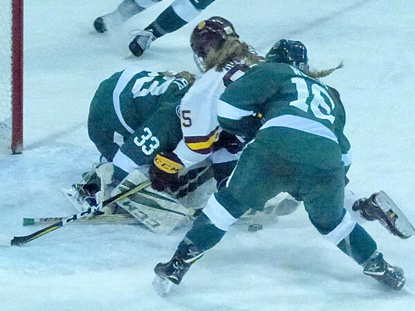 Bemidji State’s Bailey Wright made sure UMD’s Alison Rodgers couldn’t reach the puck against goaltender Kerigan Dowhy in UMD’s 4-1 second-game victory. Photo credit: John Gilbert