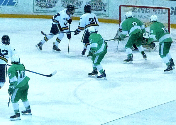Greenway of Coleraine didn’t make the state tournament, but the Raiders scored the goal of the season in the game of the season when junior defenseman Cameron Lantz frantically shot with time running out, and while his shot was 4 feet wide to the left, it hit the shaft of Hermantown defenseman Sam High’s stick, popped into the air, changed direction 20 degrees, and landed in the net — with 00.1 showing on the AMSOIL Arena clock. It tied the game 4-4, and remains an amazing feat even after Tyler Watkins scored in the second overtime to send Hermantown to the state tournament. Photo credit: John Gilbert