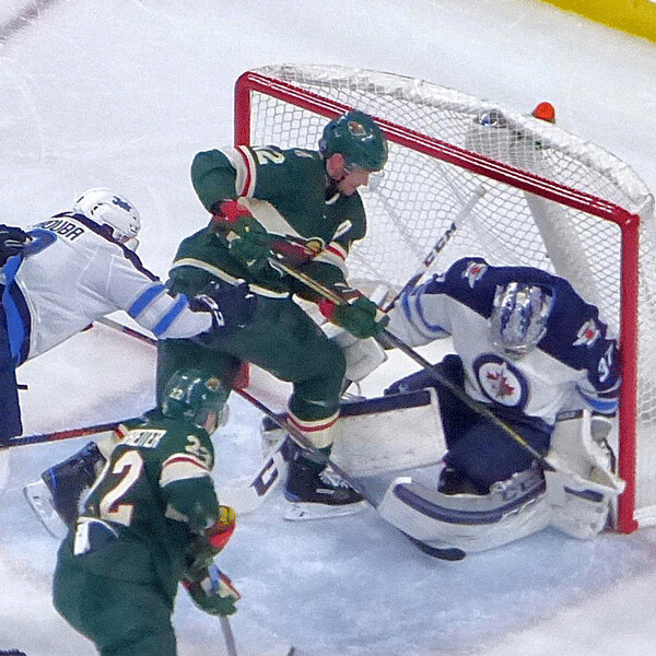 Wild center Eric Staal went hard to the net, but Winnipeg goalie Connor Hellebbuyck smothered his try for the equalizer.  Photo credit: John Gilbert