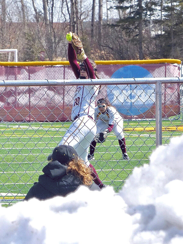 UMD's Valerie Hohol wound up for a pitch against Minnesota-Crookston from behind the snow pile last week, at Malosky Stadium. 