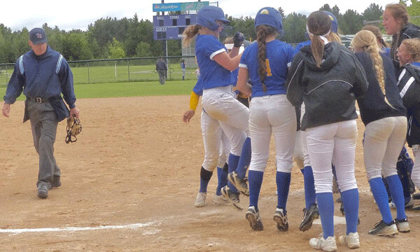 Jenna Zdebski, who joined the Esko softball team just this season, jumped into the crowd surrounding home plate after her home run helped beat Virginia 5-2 for the 7AA title. Photo credit: John Gilbert