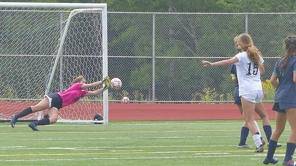 Rosemount goalkeeper Danielle Kniefel made a spectacular diving save to deflect away a shot by Andover’s Olivia Knoepfle (15) in the championship game of the Duluth East soccer invitational at Ordean. Photo credit: John Gilbert