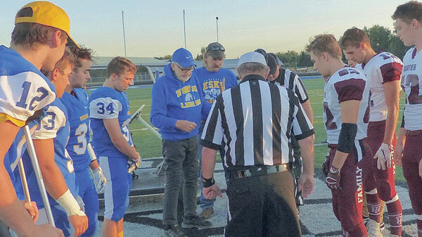 Davis Helberg, lifelong Esko resident, community booster, author, and retired Port Authority director flipped the pregame coin before the Davis Helberg Tribute game. Photo credit: John Gilbert