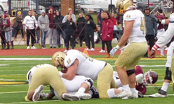 UMD quarterback John Larson scrambled early in the second quarter but was swarmed by Southwest Minnesota State defenders and left the game. Photo credit: John Gilbert