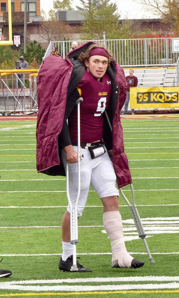 UMD's John Larson used crutches to get to the locker room at halftime and is out with the proverbial "lower body injury." Photo credit: John Gilbert