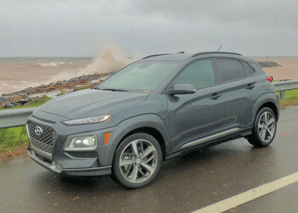 Hyundai Kona stopped on North Shore as waves crashed over a breakwater. Photo by: John Gilbert