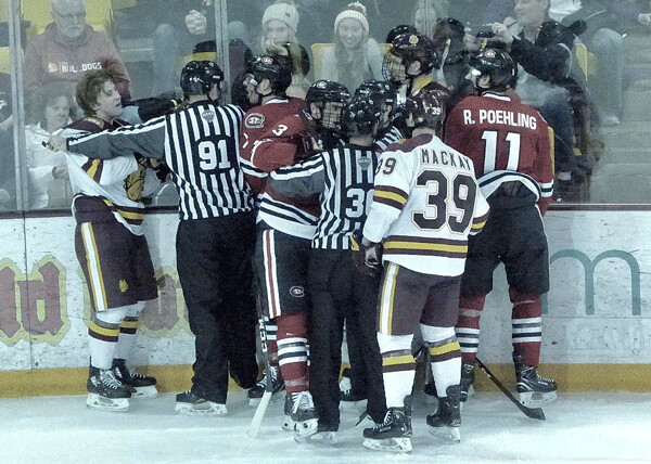 UMD’s Scott Perunovich, without his helmet, checked Ryan Poehling (11) and found himself  facing brothers Jack and Nick Poehling on St. Cloud’s three-brother line on Saturday.  Photo credit: John Gilbert