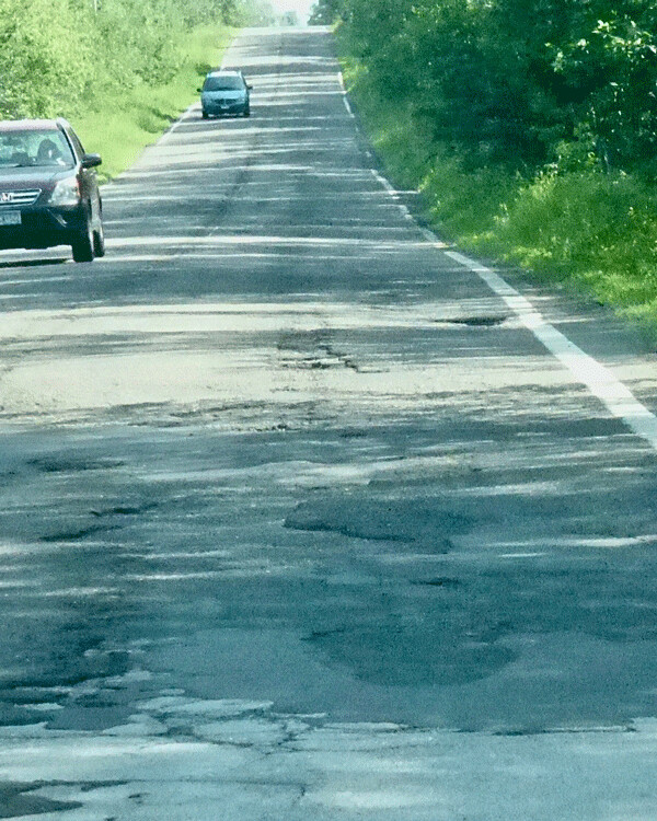 Lakewood Road surface changes from smooth to pothole territory when entering  Duluth city limits. Photo credit: John Gilbert