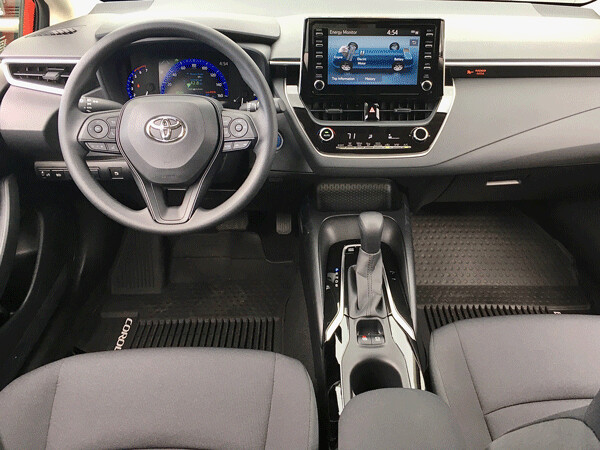 Sporty view from the driver's seat shows contemporary dash, console, and large center info screen, which is a touch-screen. Photo credit: John Gilbert