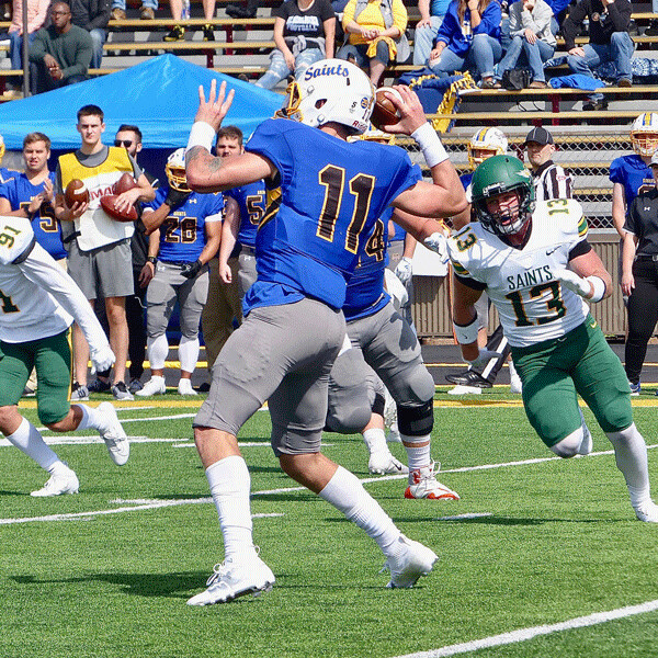  St. Scholastica quarterback Zach Edwards was cocked and ready to throw five  touchdown passes in a  41-13 victory Saturday. Photo credit: John Gilbert