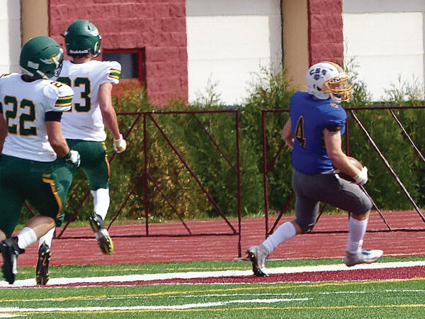 Mitchell Adrian raced 70 yards in St. Scholastica;s 4-TD second quarter outburst.  Photo credit: John Gilbert
