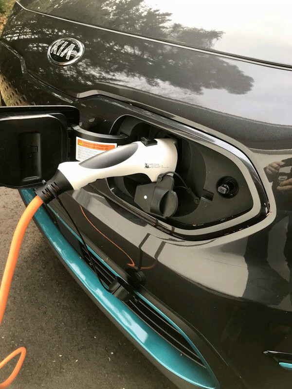 Plug logs securely into car and power outlet to recharge battery range for up to 260 miles. Photo credit: John Gilbert