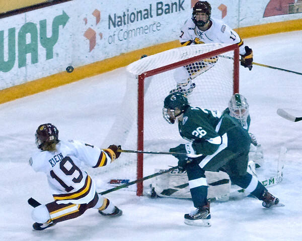 UMD also won Saturday's game, 4-2, but it wasn't easy, as Gabbie Hughes found out when her breakaway was stopped by Beavers goaltender Lauren Bench. Photo credit: John Gilbert