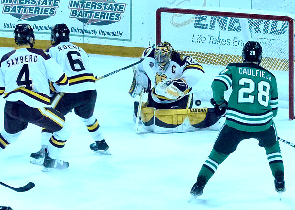North Dakota's Judd Caulfield had the best view as UMD goaltender Hunter Shepard battled in Friday's series opener but UMD came from a 3-1 deficit to win 7-4. Photo credit: John Gilbert