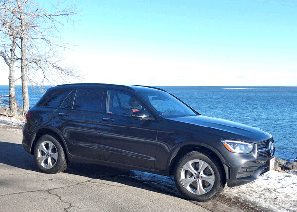 In silhouette, Lake Superior provides the backdrop to the slightly taller than the sleekest SUVs, but offering more interior space. Photo credit: John Gilbert