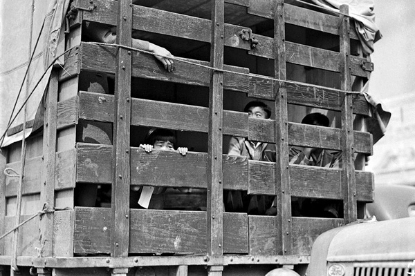 A truck packed with Japanese-American residents of San Pedro, California, leaves the city for a detention center on April 5, 1942.  Photo: Clem Albers
