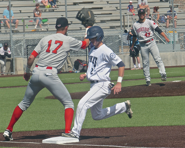 Brendan McClary hustled back to first base on a Thunder Bay pickoff try. McClary later delivered a 2-run single as the Huskies rallied from a 5-0 deficit. Photo credit: John Gilbert