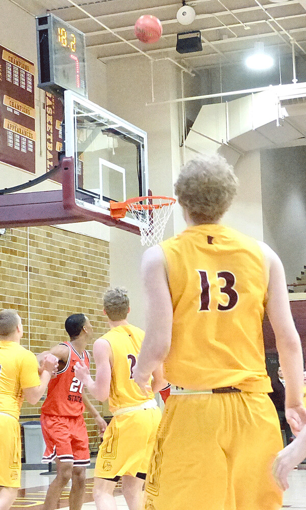 UMD redshirt freshman Ethan Youso (13) from Virginia followed the trajectory of his 3-point basket to cap UMD's 95-74 NSIC victory over St. Cloud State, which was postponed from Saturday to Monday at Romano Gym. Photo credit: John Gilbert