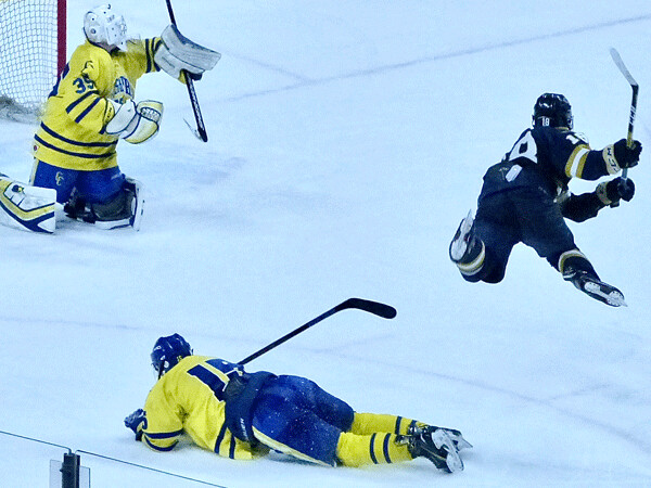 Hermantown junior defenseman went airborne as he attacked the St. Cloud Cathedral goal... 