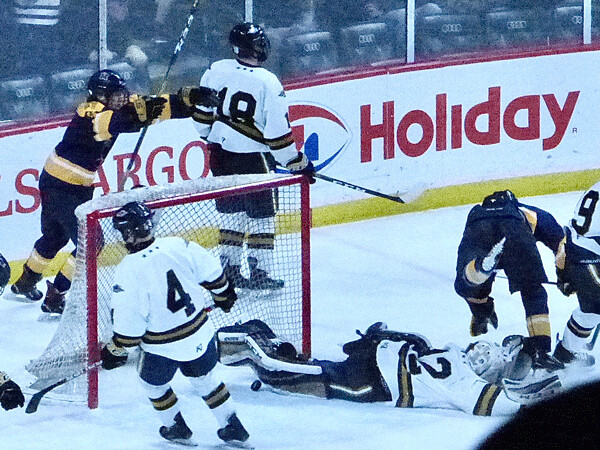  Mahtomedi's Colin Hagstrom flew over Hermantown goalie Jacob Backstrom, but he already had put the puck into the Hawks net at 2:44 of sudden-death overtime.Photo credit: John Gilbert