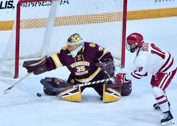 UMD's Maddie Rooney made one of her 28 saves against top-seed Wisconsin in the WCHA semifinals. Photo credit: John Gilbert