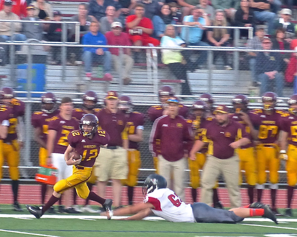 Denfeld quarterback Cody Brown eluded East defenders and led the Hunters to a 36-34 victory. Photo credit: John Gilbert